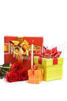 Red roses and gift boxes on a studio white background.