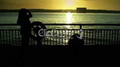 Woman silhouetted against a river 1