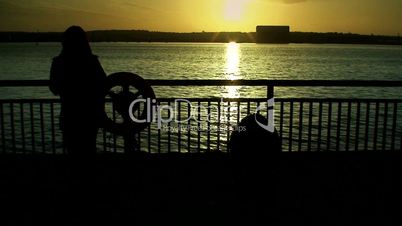Woman silhouetted against a river 2
