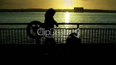 Woman silhouetted against a river 3