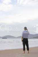 Businessman standing on beach