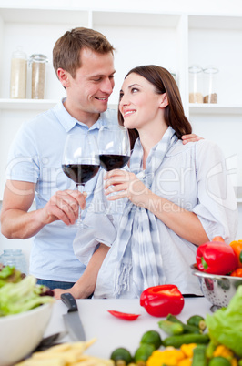 Affectionate couple drinking wine while cooking