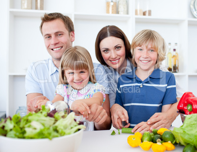 Cheerful young family cooking together
