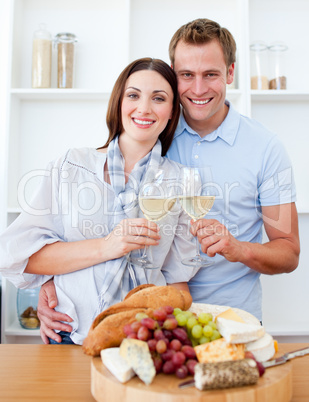 Smiling lovers drinking white wine