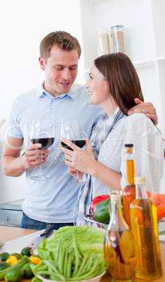 Romantic couple drinking wine while cooking