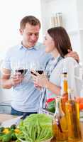 Romantic couple drinking wine while cooking