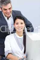 Asian businesswoman and her manager working at a computer