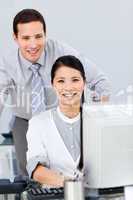 Pretty businesswoman and her colleague working at a computer