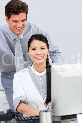 Asian businesswoman and her colleague working at a computer
