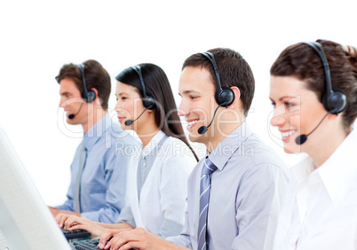 Smiling customer service agents working in a call center