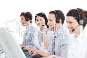 A diverse group of customer service agents working in a call cen