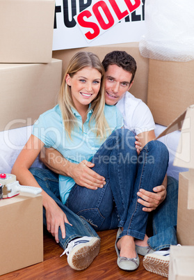 Caucasian couple embracing after move in