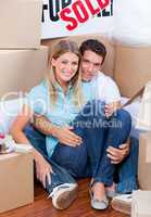 Caucasian couple embracing after move in