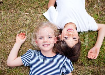 Adorable siblings lying on the grass