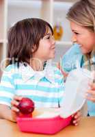 Cute little boy and his mother preparing his snack