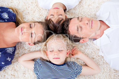 Relaxed family lying in circle on the wall-to-wall carpet