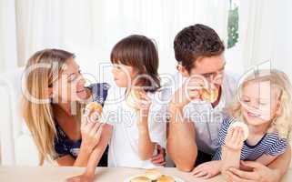 Lively family eating burgers in the living room