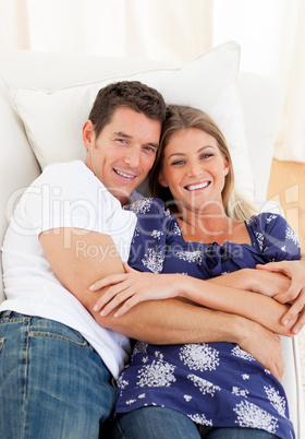 Affectionate couple lying down on sofa