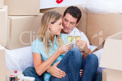 Enamored couple toasting with Champagne