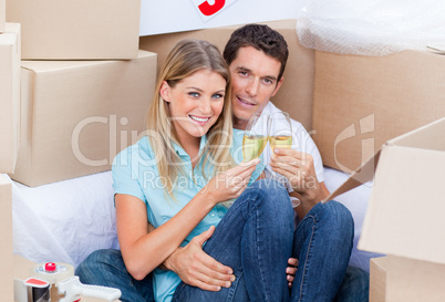 Cheerful couple toasting with Champagne