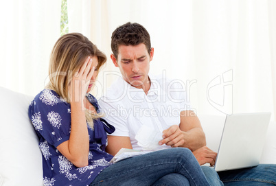 Distressed couple angry with so many bills to pay