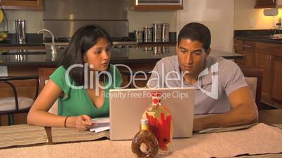 Latino Couple doing bills on computer