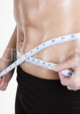 measuring tape around slim beautiful waist