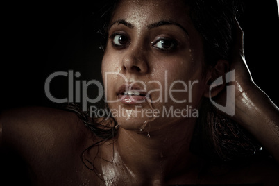 Portrait of beautiful young woman with wet face