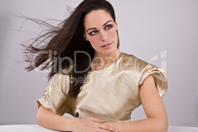 young pretty woman weraing gold fashion dress - portrait