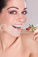 Image of beautiful girl holding strawberry enjoy
