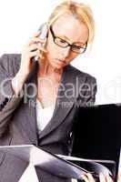 blonde businesswoman using laptop computer and mobile phone  at