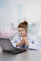 Woman with laptop drinking coffee