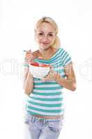 Young beautiful woman eating corn flakes