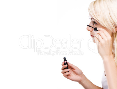 happy young woman using mascara