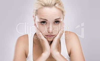 portrait of a caucasian blonde woman with toothache