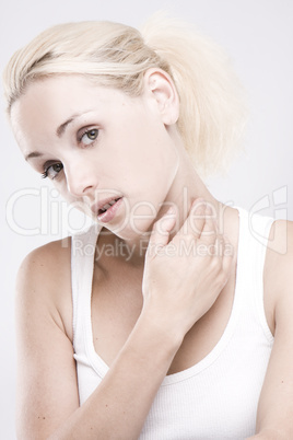 close up of a blonde woman massaging her neck