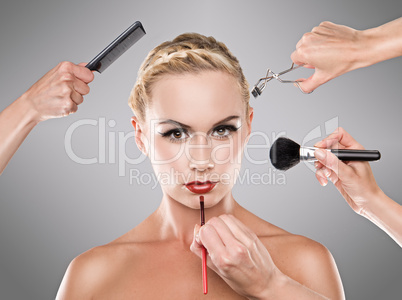 Picture shows studio makeup process of a young pretty girl