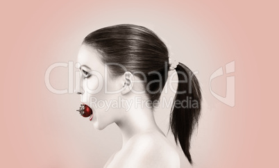 Beautiful woman biting strawberry