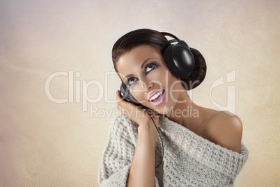 Studio portrait of a girl in headphones listening music