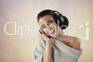 Studio portrait of a girl in headphones listening music