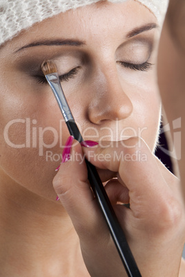 Woman having her makeup applied