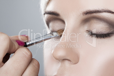 Woman having her makeup applied