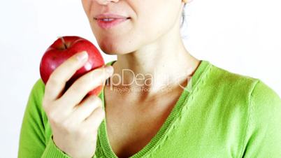 Closeup of young woman eating an apple