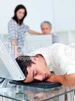 Tired businessman sleeping on his keyboard