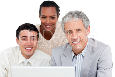 Charismatic business co-workers using a laptop