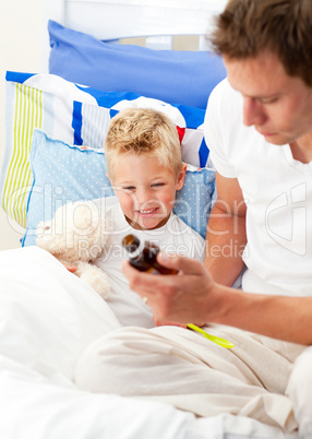 Caring man looking after his sick son