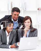 Concentrated business partners working at a computer