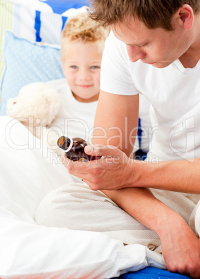 Concerned man looking after his sick son