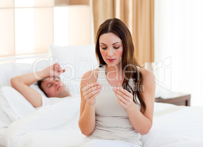 Attractive woman taking her sick husband's temperature