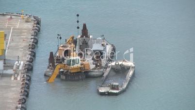 Digger being used to dredge harbour